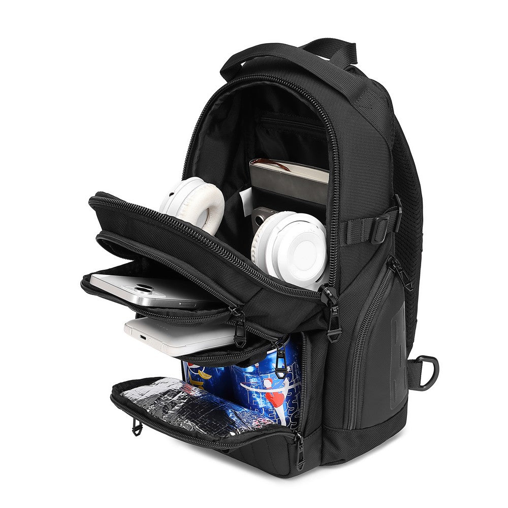 Ridge Sling 8L in Black, three-quarter angle with all compartments open showing headphones, phone, laptop, and a drink can