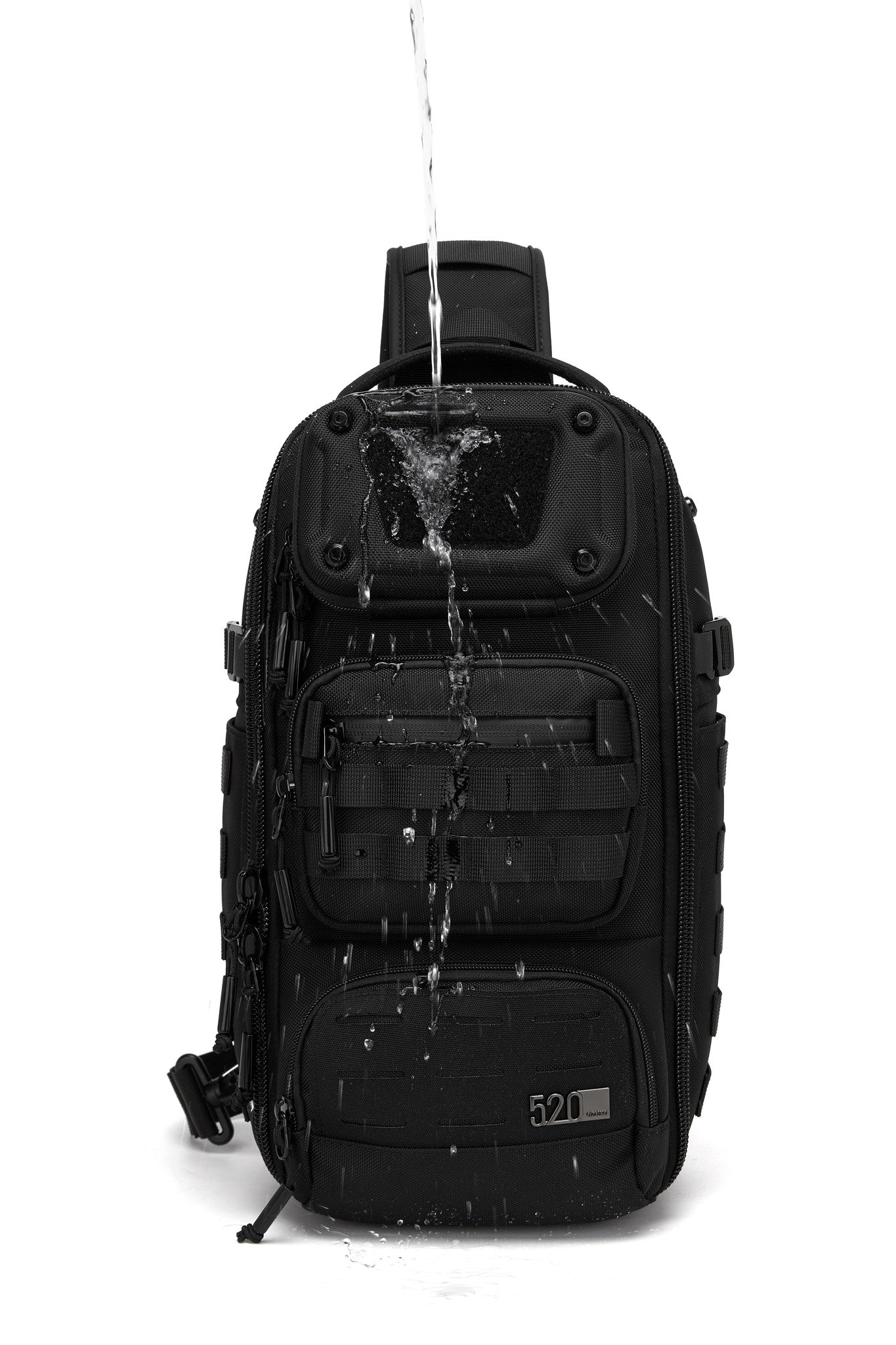Daytrip Backpack 12L in Black - front view with water poured over it to show water-resistant construction