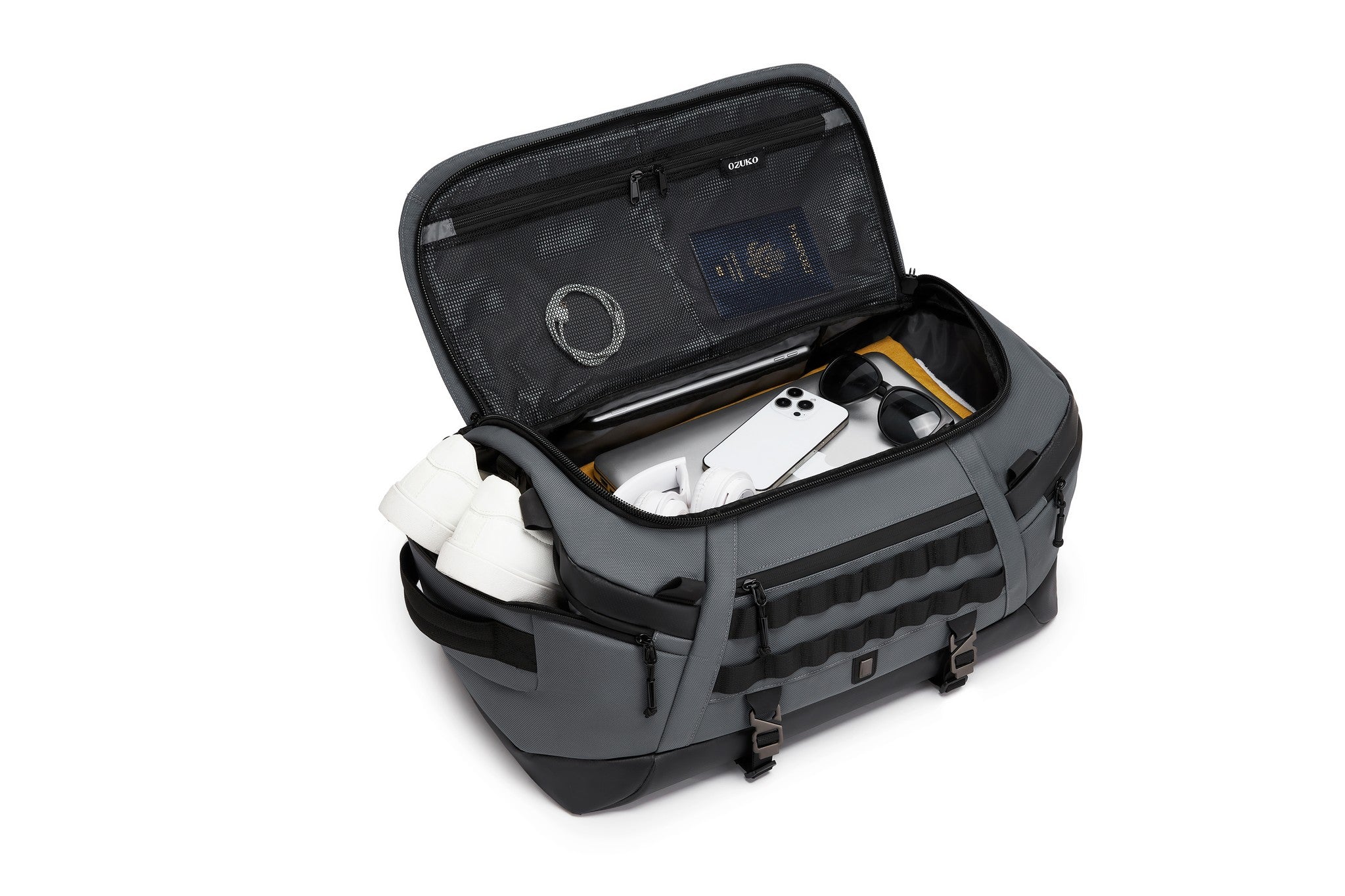 Gray Cargo Duffel 45L interior lid pocket packed with white sneakers, headphones, a tablet, a phone, and sunglasses