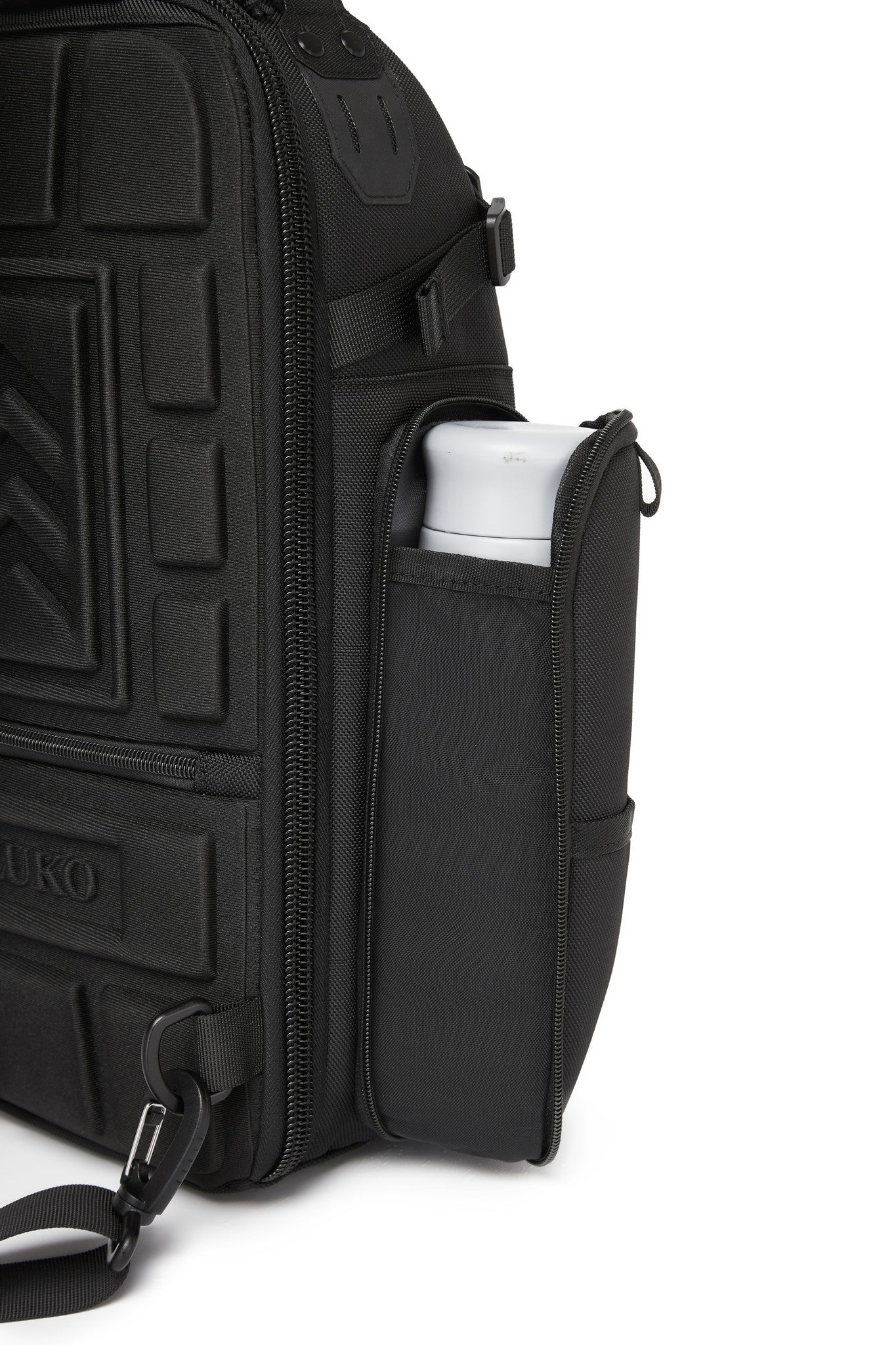 Ridge Sling Backpack 12L in Black - close-up of the side mesh pocket holding a water bottle