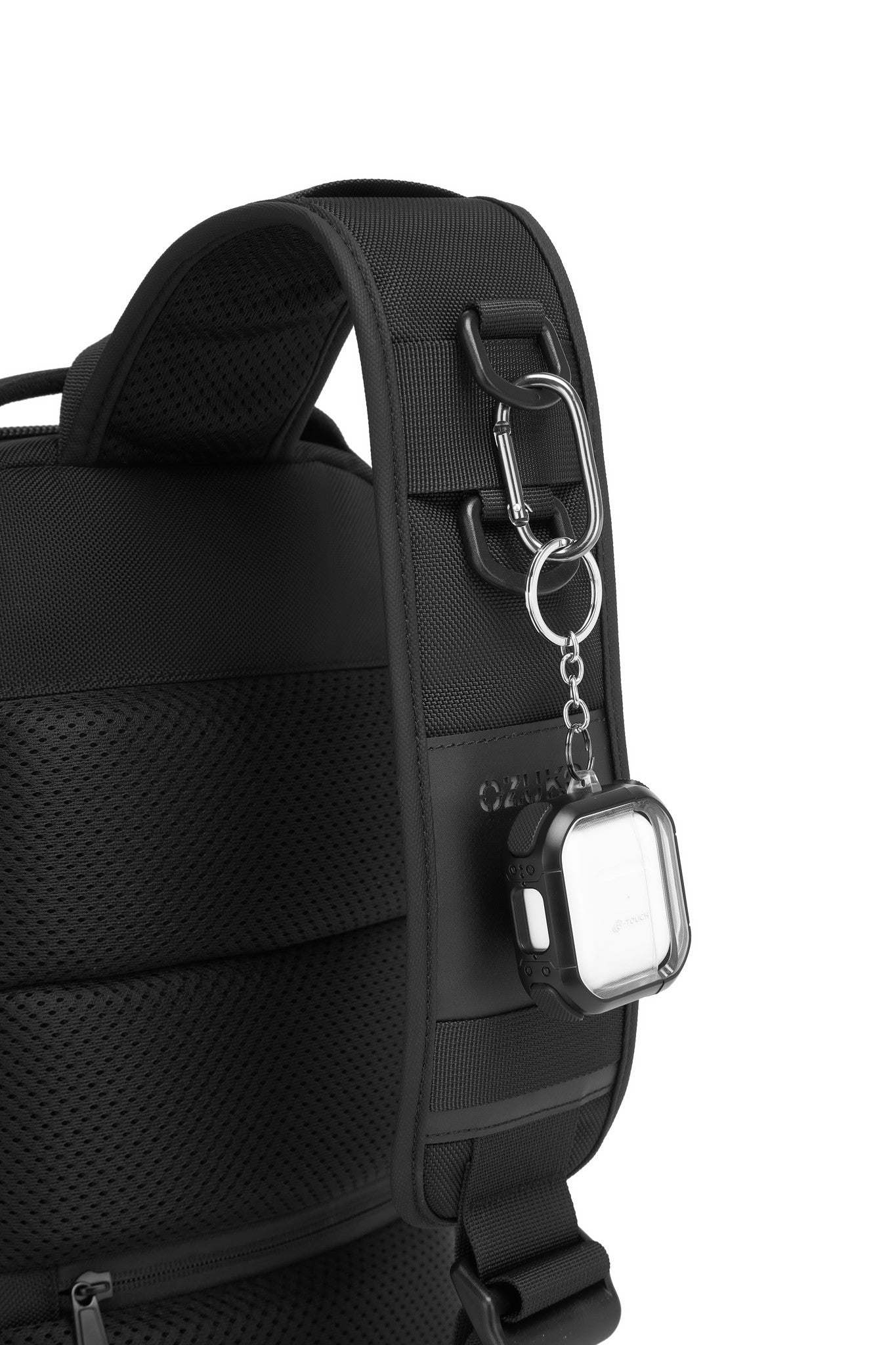 Daytrip Backpack 12L in Black - close-up of the strap D-ring and carabiner clip with a keychain accessory attached