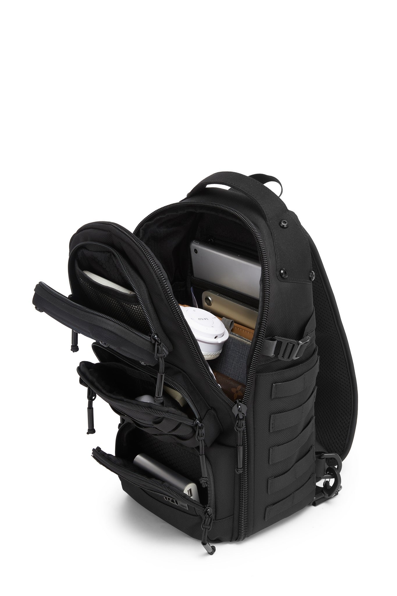 Daytrip Backpack 12L in Black - open view showing MOLLE webbing and the main compartment packed with a tablet, notebook, phone, and wallet