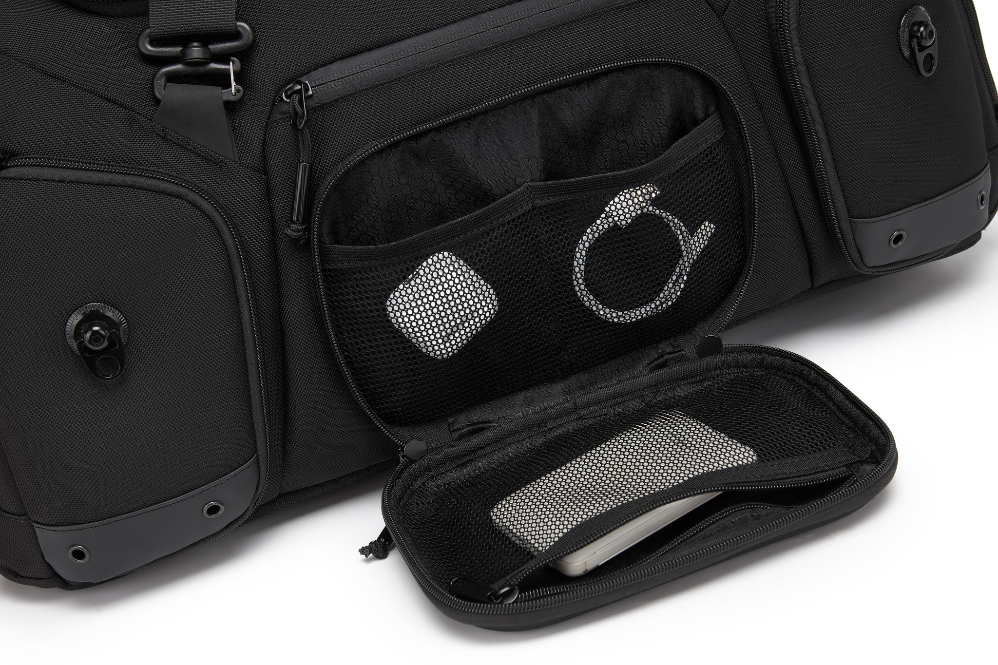 Close-up of an interior mesh pocket holding a small travel case and a keyring accessory