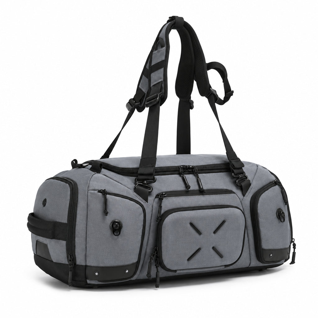Gray Voyager Duffel 40L, three-quarter angled view with the padded backpack straps deployed and front compression pocket visible