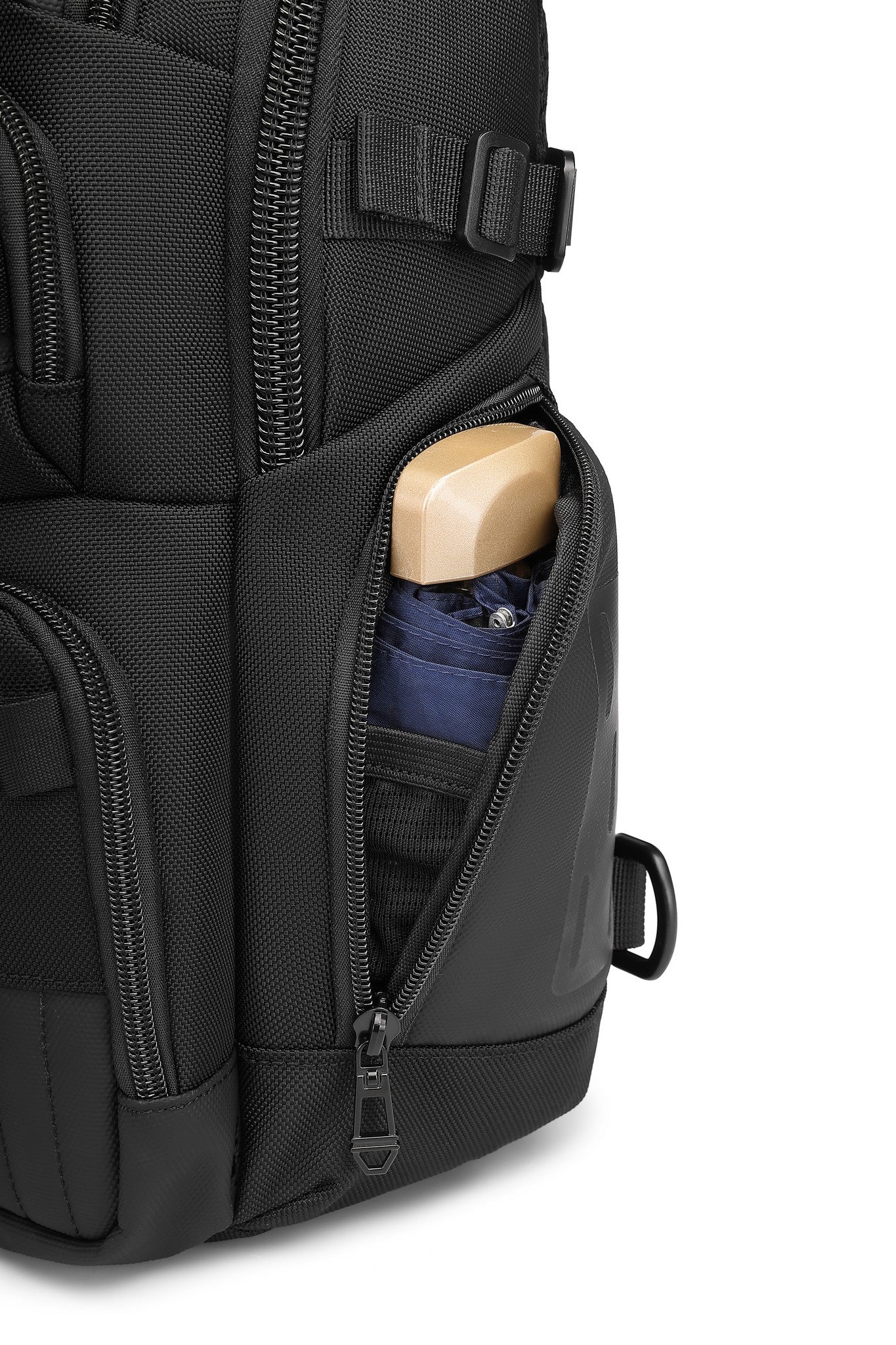 Ridge Sling 8L in Black, close-up of a side zippered pocket holding a compact umbrella