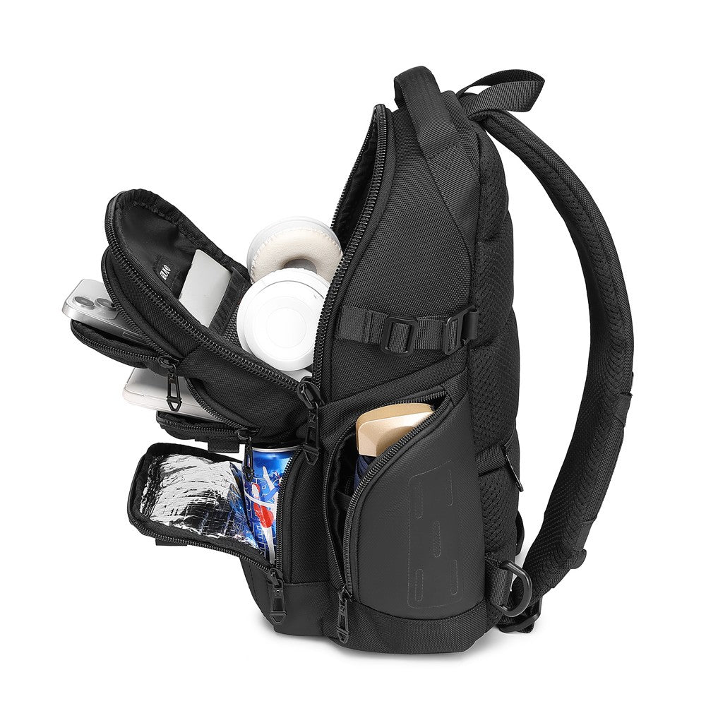 Ridge Sling 8L in Black, three-quarter angle with compartments open showing headphones, laptop, phone, and the strap-mounted card slot